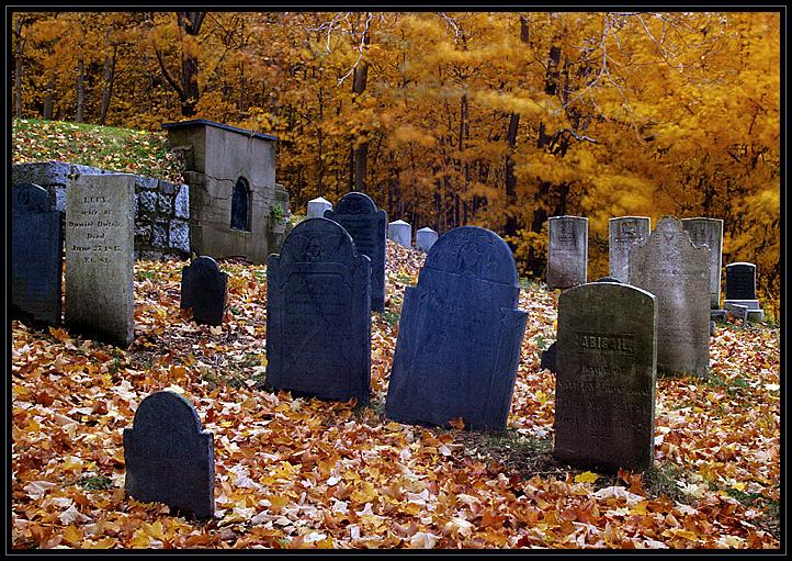 Historic cemetary in Ipswich, Massachusetts (US). It was a rainy evening. Some of the trees are a bit blurry because the breeze moved them during the long exposure.