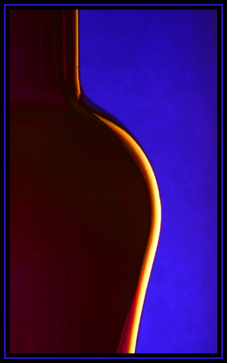 Purple bottle in front of blue paper