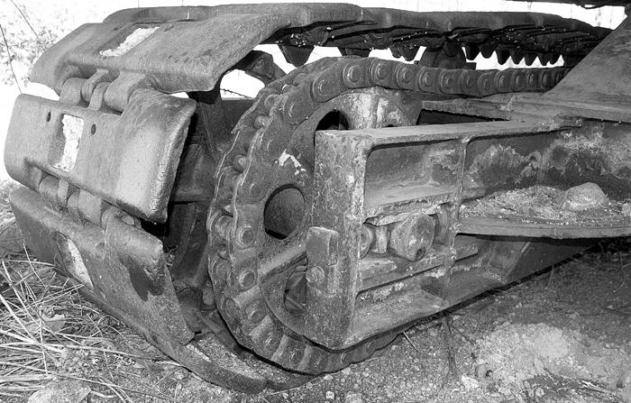 One of the crawler treads from an abandoned excavator. This tread is about four feet tall.