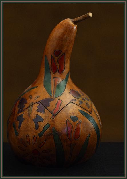 A carved and decorated gourd. Halogen lighting with white balance set in camera. Cropping, cleaning, minor levels adjustments done in Photoshop