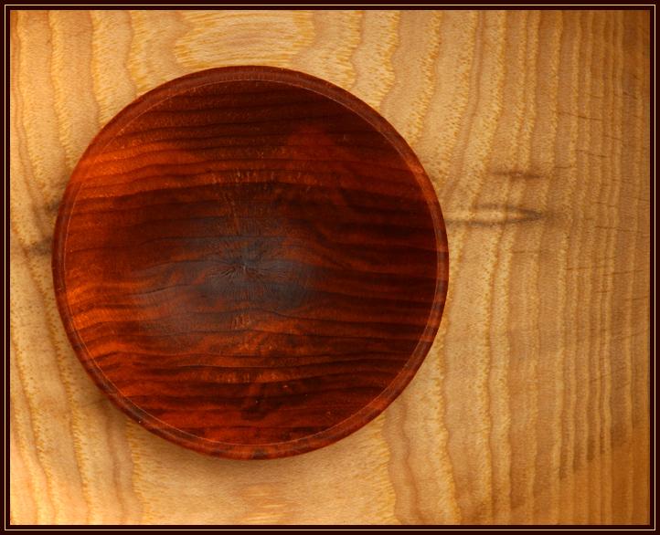 A small wooden bowl inside a larger wooden bowl. Halogen light bounced off ceiling. Custom white balance set in camera. Hot spots burnt out in Photoshop.