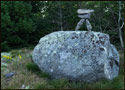 A small pile of balanced rocks found on a hilltop in the woods of Essex, Massachusetts (US).
