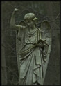 A statue of an angel on a tombstone in Pine Grove Cemetery in Lynn, Massachusetts (US). Taken in the rain on an unusually warm January evening.