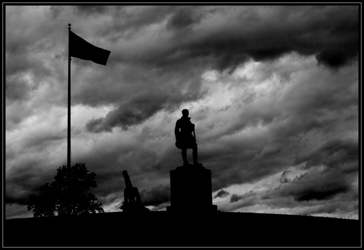 Storm clouds behind the war memorial in Pine Grove Cemetary, Lynn, MA (US).